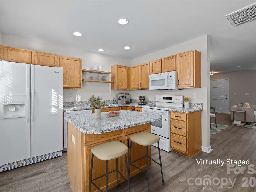 209 Primrose Walk, Fort Mill, SC 29715.  MLS# CAR4346413, YatesRealty ID 14281. Center island with seating provides additional prep space, storage, and casual dining space.