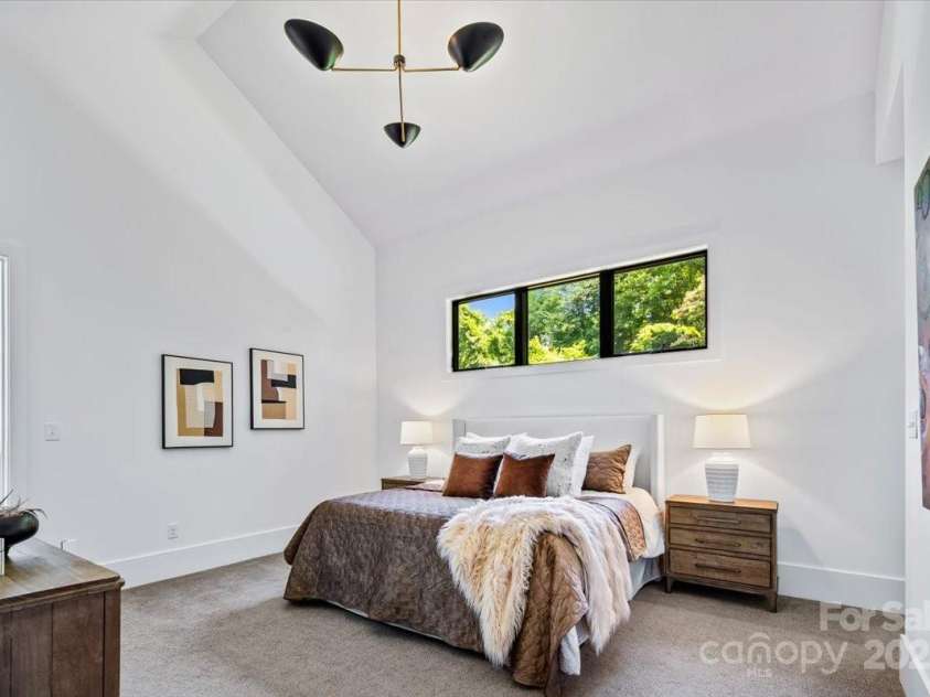 3304 Mar Vista Circle, Charlotte, NC 28209.  MLS# CAR4269142, YatesRealty ID 1429. Primary bedroom on main features 15'8' ceiling, direct access to outdoor living, and two walk in closets prewired for custom closet systems and a makeup vanity