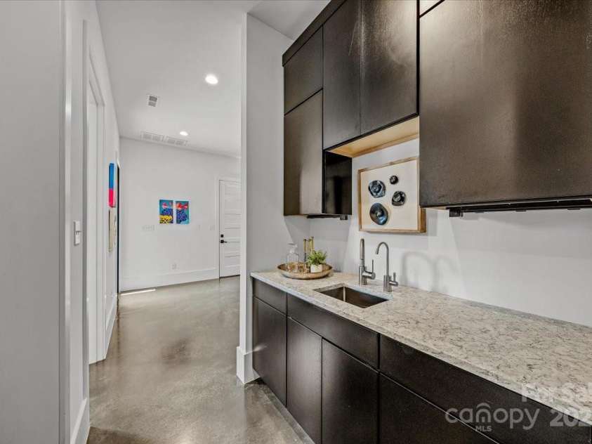 3304 Mar Vista Circle, Charlotte, NC 28209.  MLS# CAR4269142, YatesRealty ID 1429. Wet bar area with sink and storage just off the kitchen.  Provides access to pantry designed for a commercial swinging door and prewired/plumbed for refrigerator, ice maker connection, cabinetry and countertops