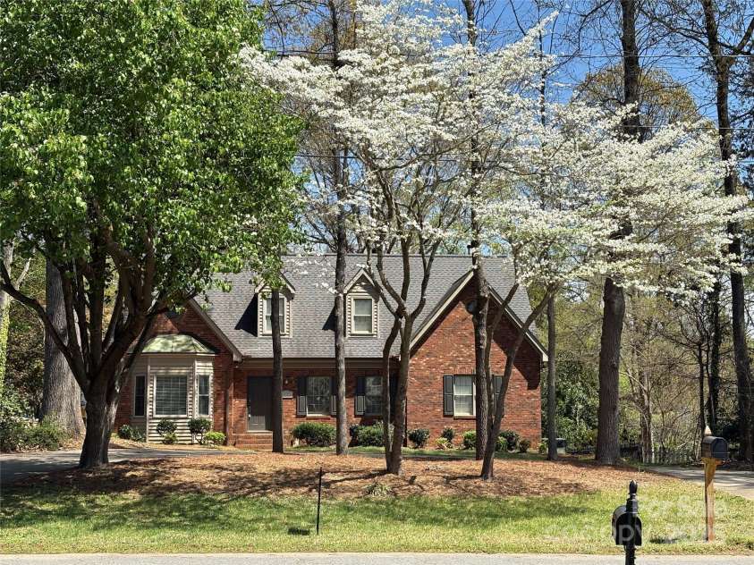 119 Lakenheath Lane, Matthews, NC 28105.  MLS# CAR4241430, YatesRealty ID 14292. Front of home with dogwood in bloom