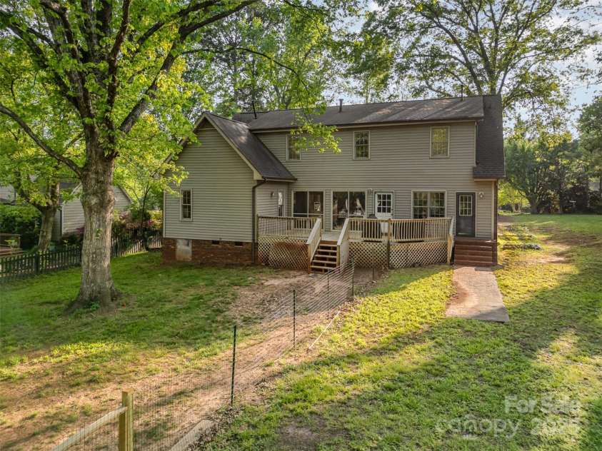 119 Lakenheath Lane, Matthews, NC 28105.  MLS# CAR4241430, YatesRealty ID 14292. Rear of home with large backyard