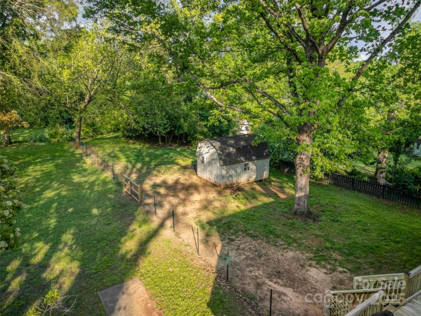 119 Lakenheath Lane, Matthews, NC 28105.  MLS# CAR4241430, YatesRealty ID 14292. Rear of home with large shed divided for dogs