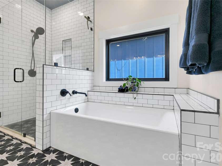 71 Hidden Pond Lane, Brevard, NC 28712.  MLS# CAR4367829, YatesRealty ID 14300. Large walk-in shower and soaking tub