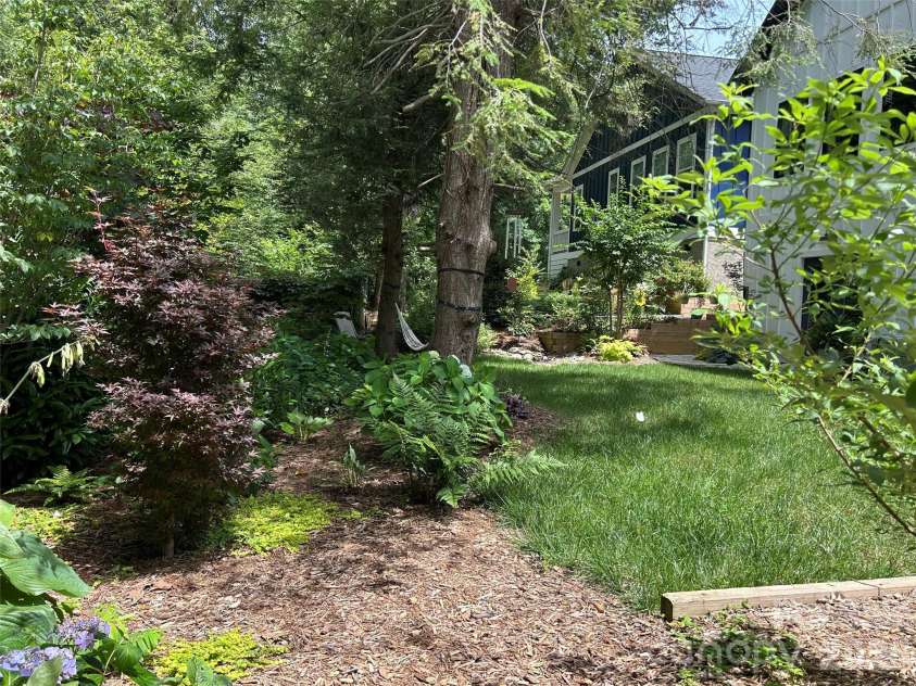 71 Hidden Pond Lane, Brevard, NC 28712.  MLS# CAR4367829, YatesRealty ID 14300. Low maintenance landscaped backyard.