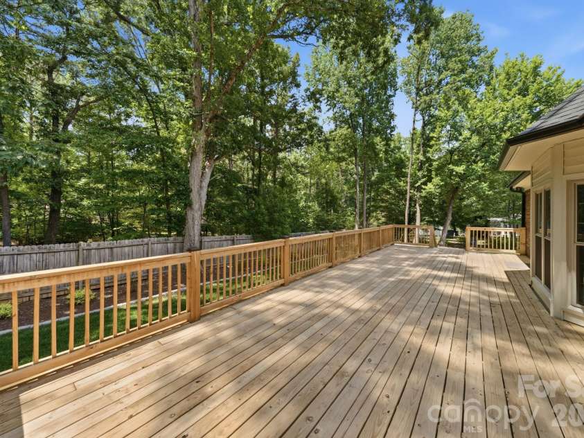 5243 Mintridge Road, Mint Hill, NC 28227.  MLS# CAR4358106, YatesRealty ID 14357. Brand new deck expands the length of the back of the house with 2 separate entrances