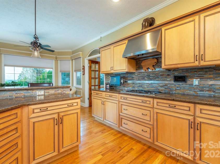 59 Carriage Highlands Court, Hendersonville, NC 28791.  MLS# CAR4243182, YatesRealty ID 14360. A natural gas range and ample counter space—kitchen is perfect for cooking and entertaining.