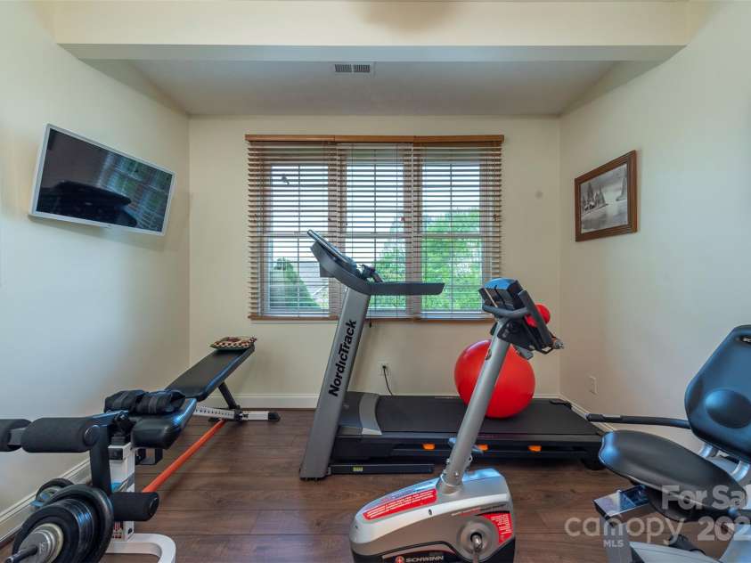 59 Carriage Highlands Court, Hendersonville, NC 28791.  MLS# CAR4243182, YatesRealty ID 14360. Currently an exercise room, but easily convertible into an art studio or home office to suit your needs.