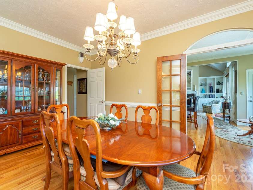 59 Carriage Highlands Court, Hendersonville, NC 28791.  MLS# CAR4243182, YatesRealty ID 14360. Dining room flows easily from the sitting area—perfect for entertaining