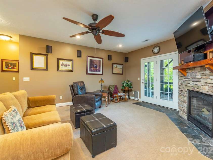 59 Carriage Highlands Court, Hendersonville, NC 28791.  MLS# CAR4243182, YatesRealty ID 14360. Game night, movie time, or just relaxing—this room is the perfect place to unwind.