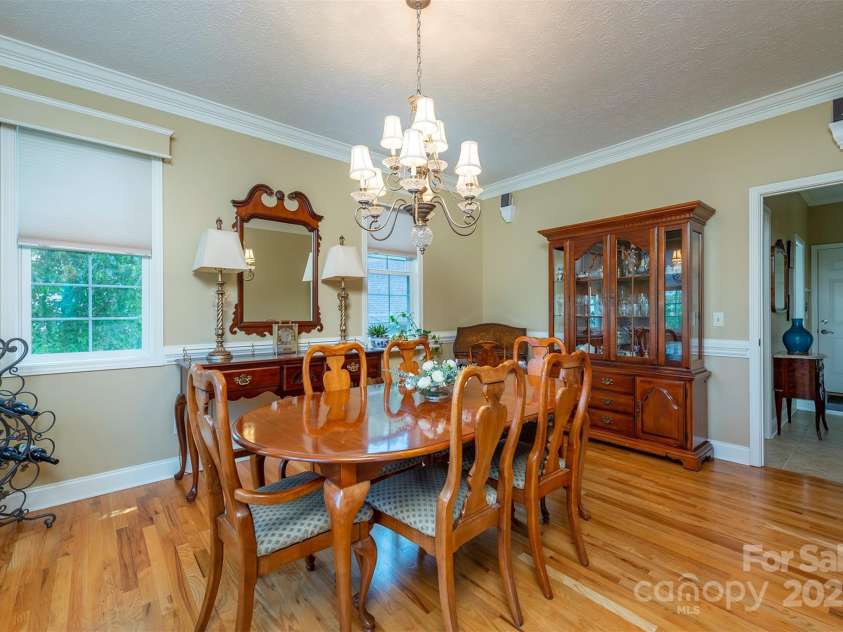 59 Carriage Highlands Court, Hendersonville, NC 28791.  MLS# CAR4243182, YatesRealty ID 14360. Main level features continuous oak flooring—rich in style and quality.