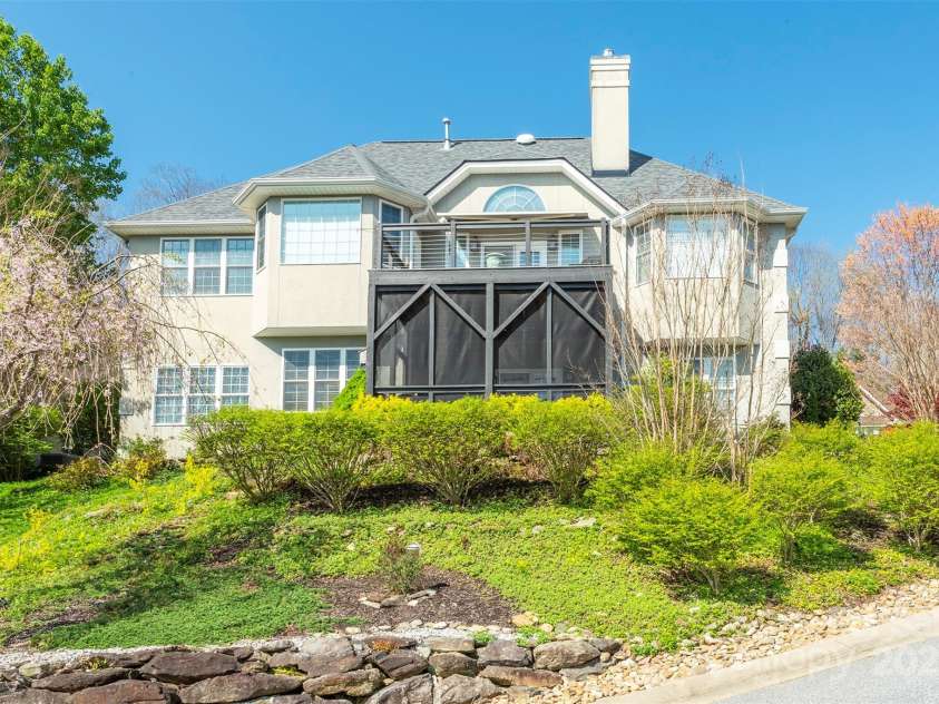 59 Carriage Highlands Court, Hendersonville, NC 28791.  MLS# CAR4243182, YatesRealty ID 14360. Open deck on the main level and a screened porch below—perfect for enjoying views and nature.