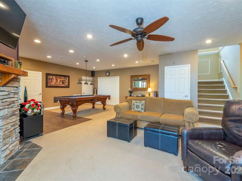59 Carriage Highlands Court, Hendersonville, NC 28791.  MLS# CAR4243182, YatesRealty ID 14360. Perfect for making memories—this recreation room is made for gatherings and fun times with loved ones.