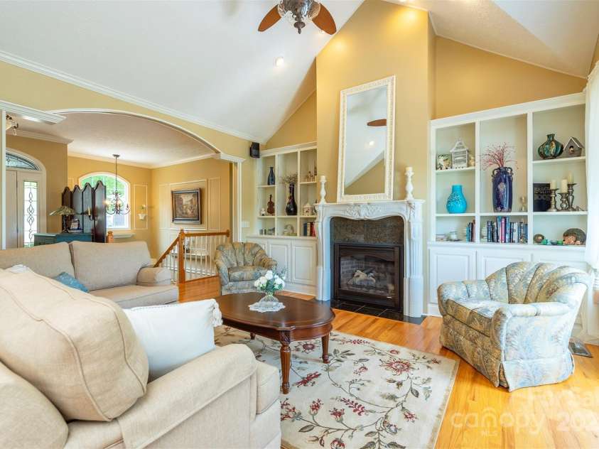 59 Carriage Highlands Court, Hendersonville, NC 28791.  MLS# CAR4243182, YatesRealty ID 14360. Vaulted ceilings and soft archways, cozy fireplace and custom built ins add character and style throughout.