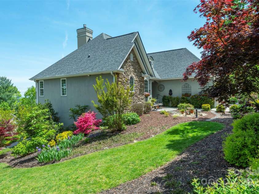 59 Carriage Highlands Court, Hendersonville, NC 28791.  MLS# CAR4243182, YatesRealty ID 14360. Year round foliage and beautifully maintained yard!