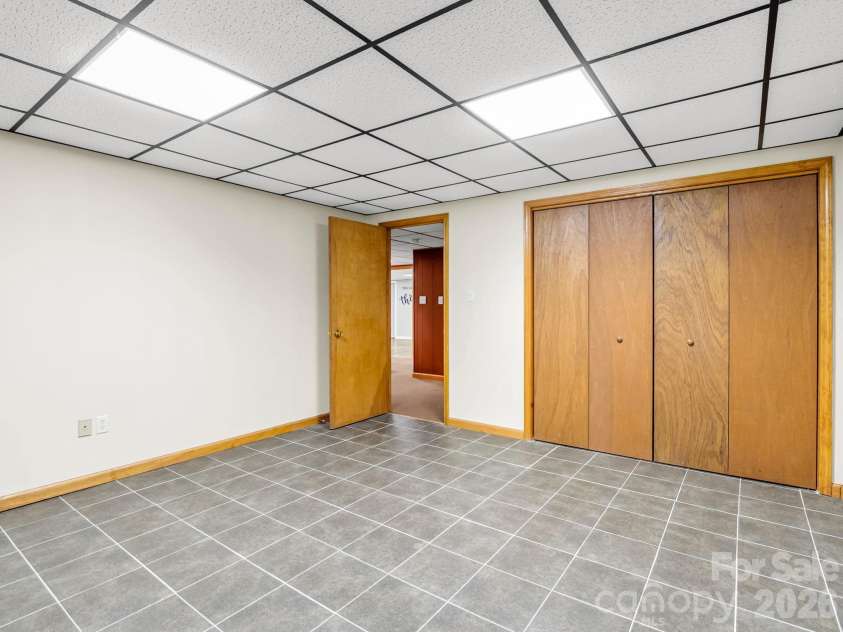 10 Chestnut Ridge Road, Mills River, NC 28759.  MLS# CAR4412466, YatesRealty ID 14367. Lower level finished Flex Space / Storage Room with tile floor