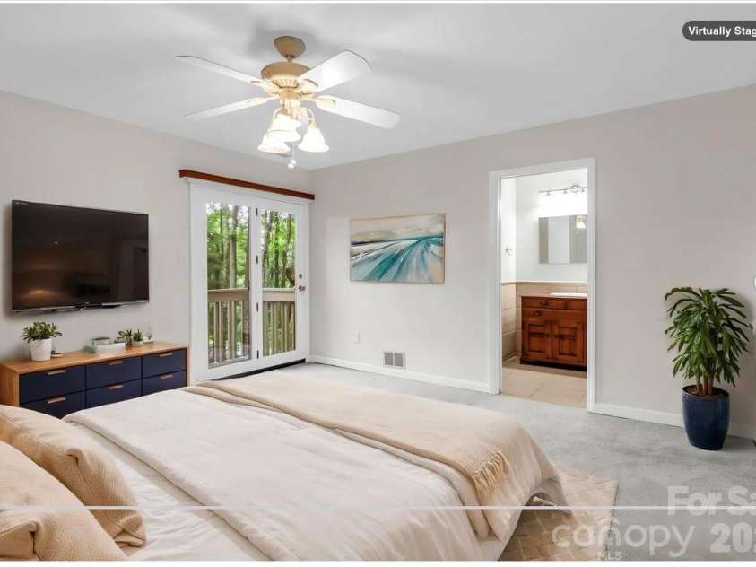 10 Chestnut Ridge Road, Mills River, NC 28759.  MLS# CAR4412466, YatesRealty ID 14367. Virtually staged: Primary Bedroom with private deck, en suite bathroom, large tile shower, walk-in closet
