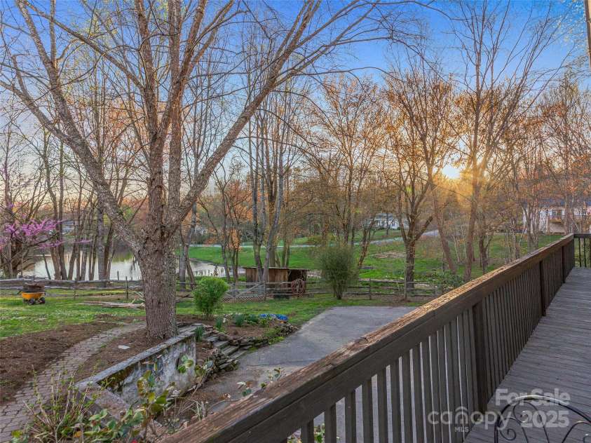 34 Ivy Lane, Fletcher, NC 28732.  MLS# CAR4242162, YatesRealty ID 14376. Sunset water, pasture and mountain views from the deck