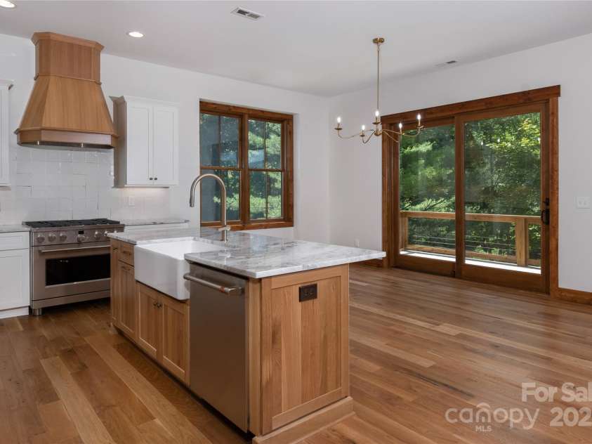 750 Silver Springs Drive, Banner Elk, NC 28604.  MLS# CAR4160928, YatesRealty ID 144. Chef's kitchen with custom solid wood cabinets, stainless steel appliances, farmhouse sink & dining room overlooking 2 story living room