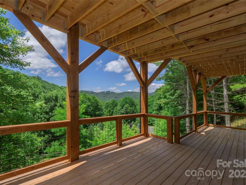 750 Silver Springs Drive, Banner Elk, NC 28604.  MLS# CAR4160928, YatesRealty ID 144. Over 1,200 square feet of outdoor space including main level porte-cochere, covered porches with majestic, private mountain & neighborhood pond views