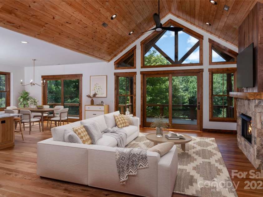 750 Silver Springs Drive, Banner Elk, NC 28604.  MLS# CAR4160928, YatesRealty ID 144. Vaulted living room with floor to ceiling sliding doors & windows and gas fireplace