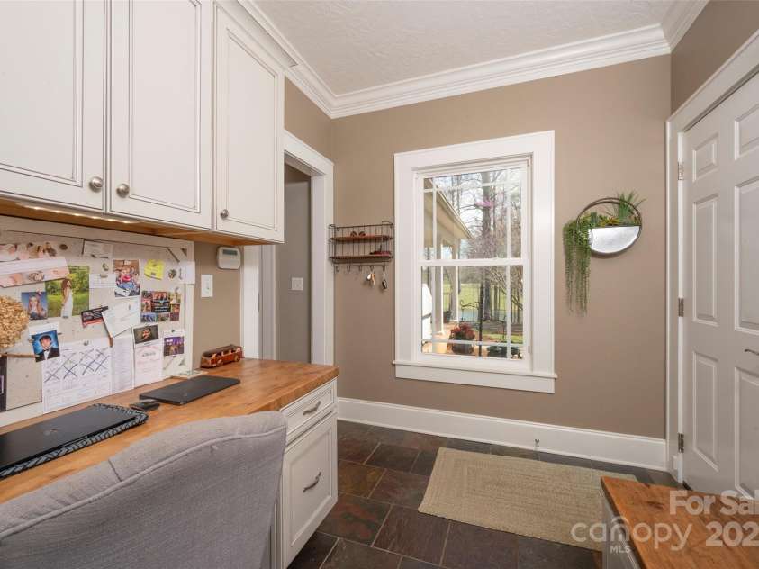 153 Finn Hollow Lane, Advance, NC 27006.  MLS# CAR4241337, YatesRealty ID 14402. Built-in Desk in Laundry Room has filing cabinet drawer.