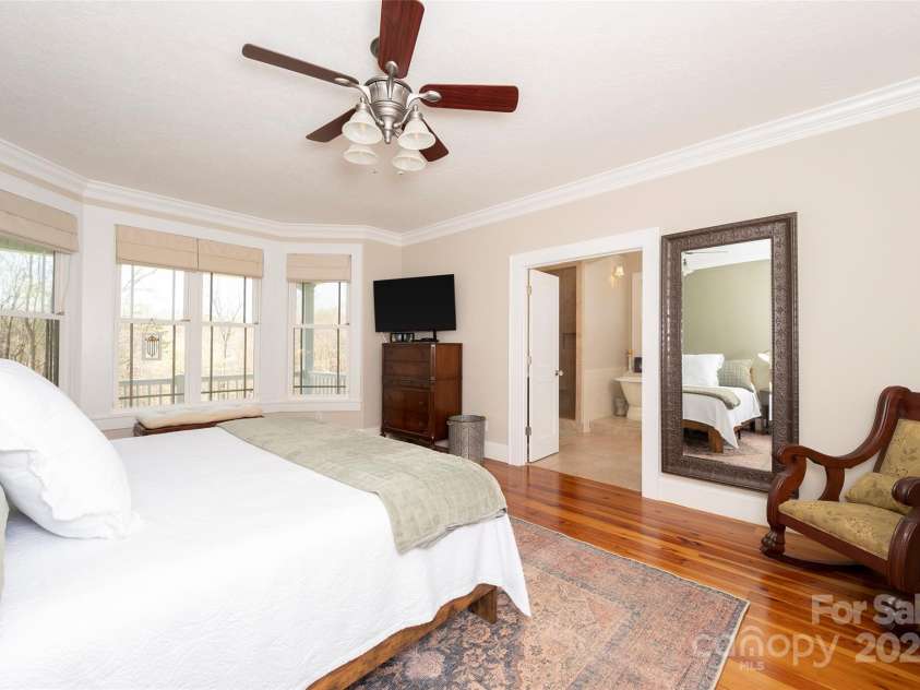 153 Finn Hollow Lane, Advance, NC 27006.  MLS# CAR4241337, YatesRealty ID 14402. Main Level Primary Suite has French Doors to luxurious spa bathroom