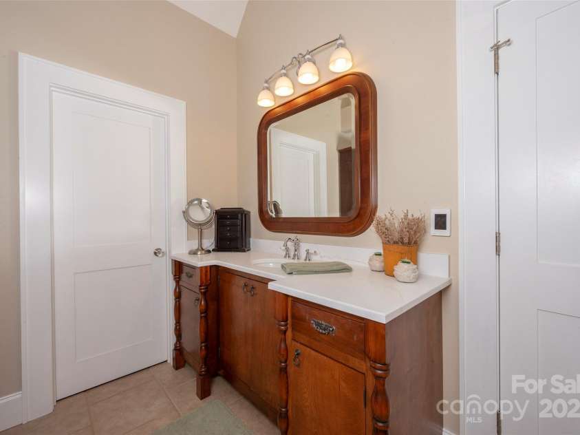 153 Finn Hollow Lane, Advance, NC 27006.  MLS# CAR4241337, YatesRealty ID 14402. Separate Vanities feature custom cabinetry and furniture-style quality finishes