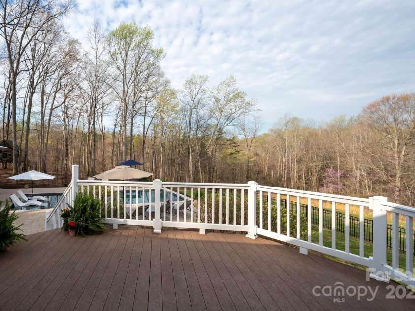 153 Finn Hollow Lane, Advance, NC 27006.  MLS# CAR4241337, YatesRealty ID 14402. Trex Deck overlooking fenced backyard and saltwater pool