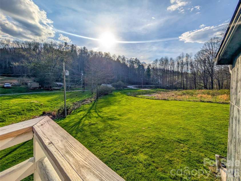 65 Happy Hollow Road, Green Mountain, NC 28740.  MLS# CAR4363965, YatesRealty ID 14402. View of property and mountains from deck