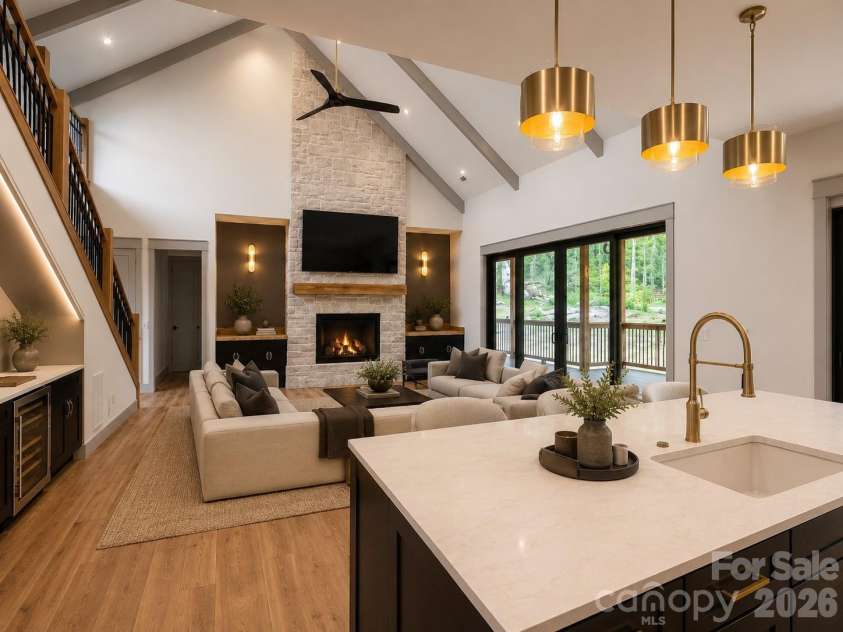 25 Emory Paige Road, Weaverville, NC 28787.  MLS# CAR4332863, YatesRealty ID 14417. Vaulted great room with floor-to-ceiling stone fireplace and expansive sliding glass doors. Virtually Staged.