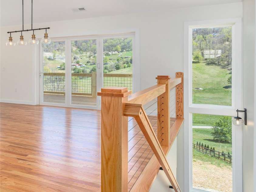 191 Aster Ridge Drive, Waynesville, NC 28786.  MLS# CAR4248737, YatesRealty ID 14439. Open stair case with two view windows