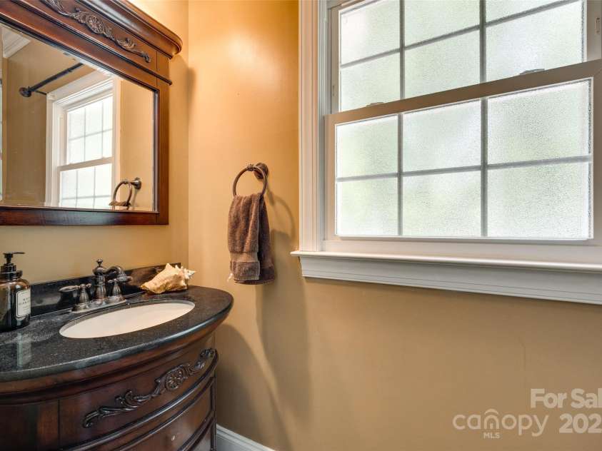 7122 Forest Ridge Road, Matthews, NC 28104.  MLS# CAR4249033, YatesRealty ID 14454. 1/2 bath as you come in from gaage that has seperate door to outside close to pool area