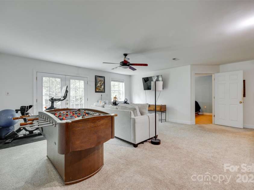 7122 Forest Ridge Road, Matthews, NC 28104.  MLS# CAR4249033, YatesRealty ID 14454. Basement living area French Doors to outside patio