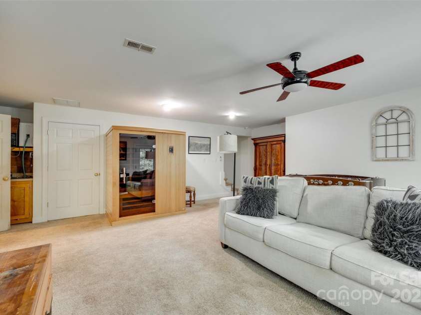 7122 Forest Ridge Road, Matthews, NC 28104.  MLS# CAR4249033, YatesRealty ID 14454. Basement Living Area with stair to upstairs in back right