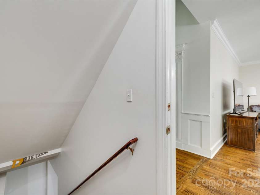7122 Forest Ridge Road, Matthews, NC 28104.  MLS# CAR4249033, YatesRealty ID 14454. Stairs to basement from living room area