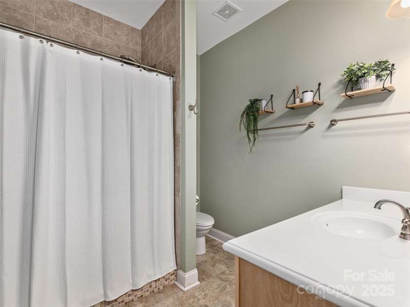 4 Greene Lane, Fletcher, NC 28732.  MLS# CAR4256056, YatesRealty ID 14458. Primary bath with walk-in tiled shower