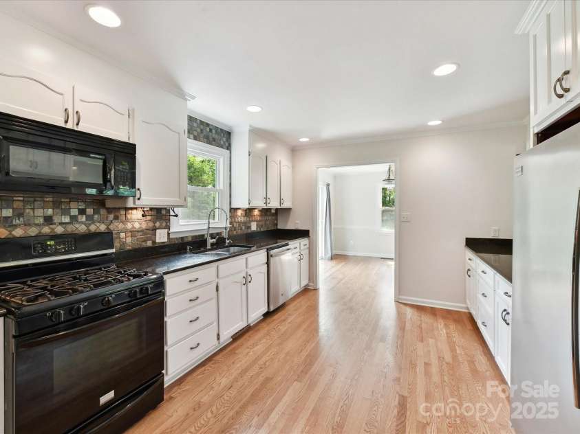 915 Gate Road, Monroe, NC 28112.  MLS# CAR4245908, YatesRealty ID 14460. Gas cooktop and freshly painted kitchen cabinets