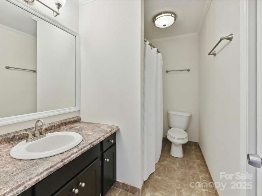 915 Gate Road, Monroe, NC 28112.  MLS# CAR4245908, YatesRealty ID 14460. Secondary bathroom w/ freshly painted cabinets + linen closet