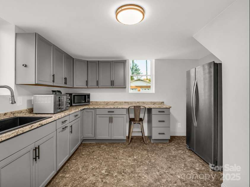2115 Stoney View Court, Hendersonville, NC 28792.  MLS# CAR4310001, YatesRealty ID 14461. Versatile lower-level space complete with a full kitchenette, ample storage, and laundry area — ideal for in-laws, guests, or extended stays