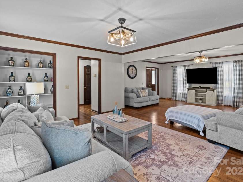 1212 Ridge Street, Albemarle, NC 28001.  MLS# CAR4216901, YatesRealty ID 14467. Gorgeous living room features wood burning fireplace