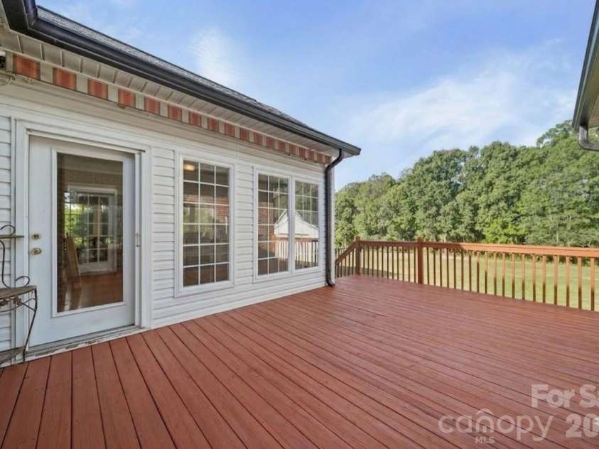 5106 Pond Bluff Drive, Monroe, NC 28112.  MLS# CAR4358314, YatesRealty ID 14505. Back deck with access to Sun Room and stairs to backyard