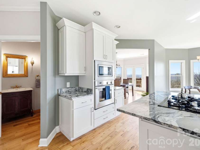 301 Forge Crest Drive, Mills River, NC 28759.  MLS# CAR4369584, YatesRealty ID 14515. Kitchen next to half bath