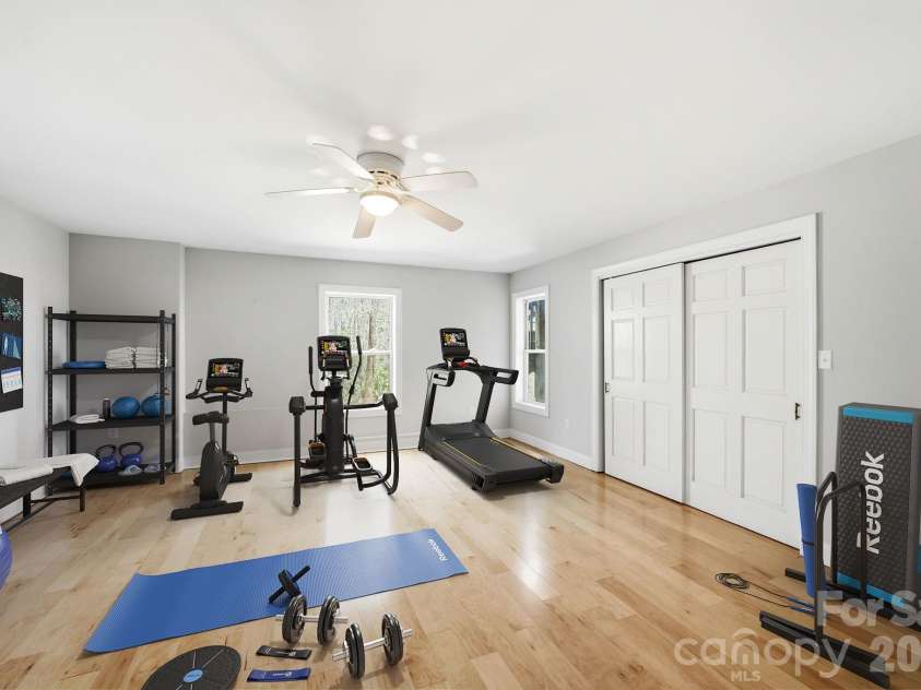 301 Forge Crest Drive, Mills River, NC 28759.  MLS# CAR4369584, YatesRealty ID 14515. Lower level bedroom/workout room. Virtually Staged