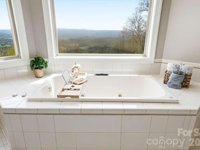 301 Forge Crest Drive, Mills River, NC 28759.  MLS# CAR4369584, YatesRealty ID 14515. Upper level Primary suite 1st bathroom