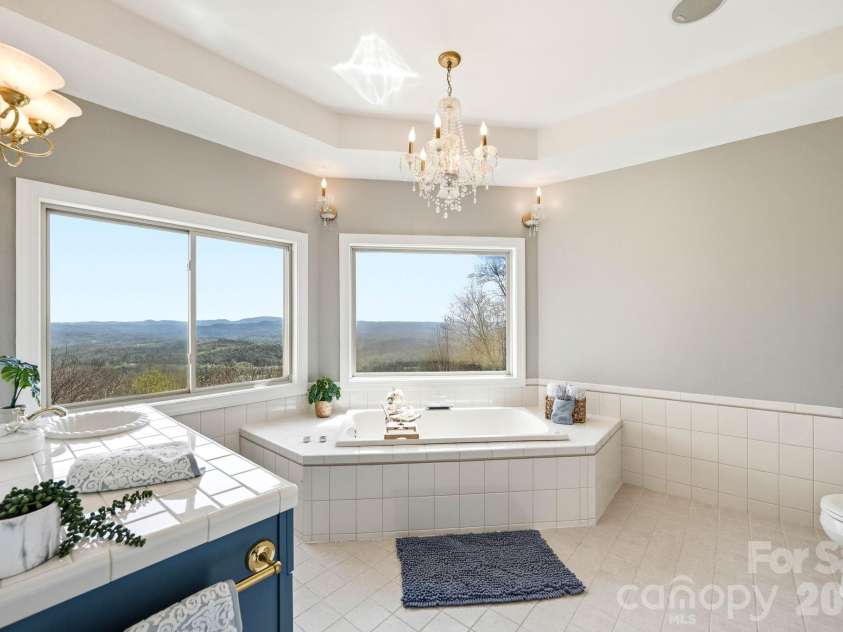 301 Forge Crest Drive, Mills River, NC 28759.  MLS# CAR4369584, YatesRealty ID 14515. Upper level Primary suite 1st bathroom