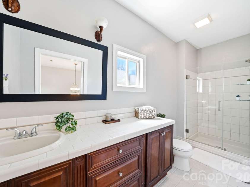 301 Forge Crest Drive, Mills River, NC 28759.  MLS# CAR4369584, YatesRealty ID 14515. Upper level Primary suite 2nd bathroom