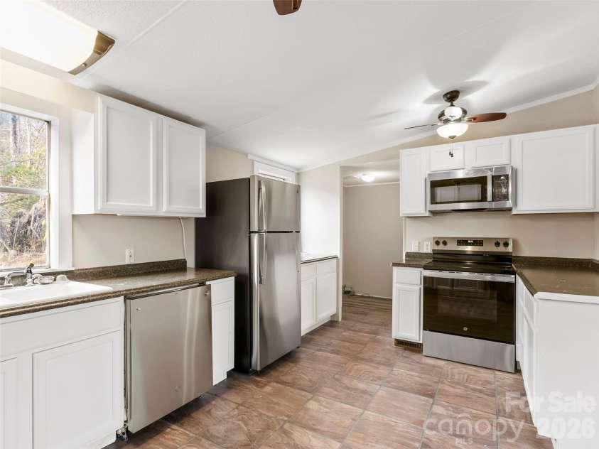 163 Connie Drive, Fletcher, NC 28732.  MLS# CAR4361657, YatesRealty ID 14519. Kitchen into laundry room