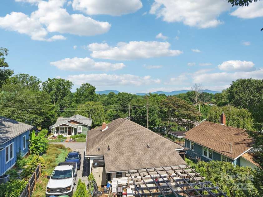 68 1/2 Nevada Avenue, Asheville, NC 28806.  MLS# CAR4280825, YatesRealty ID 1453. Mountains peaking from back sunroom, perfect spot to add a second level viewing deck!
