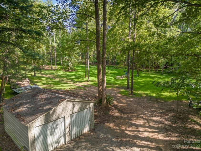 2756 Peachtree Road, Statesville, NC 28625.  MLS# CAR4072282, YatesRealty ID 1456. Behind the metal building in the back is a beautiful open recreational area for group/family picnics and gatherings. 