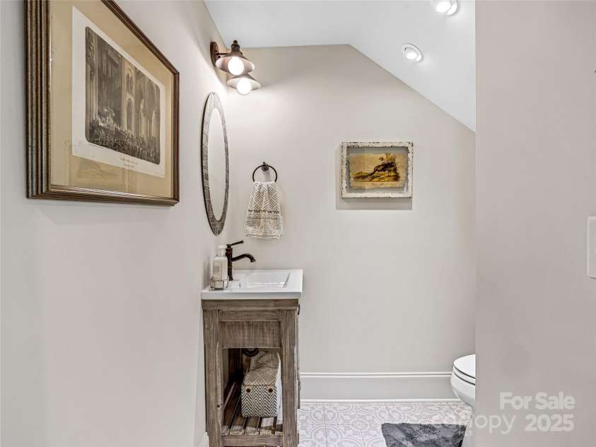 294 Main Street, Brevard, NC 28712.  MLS# CAR4260783, YatesRealty ID 14562. A cute half bath hidden under the stairs